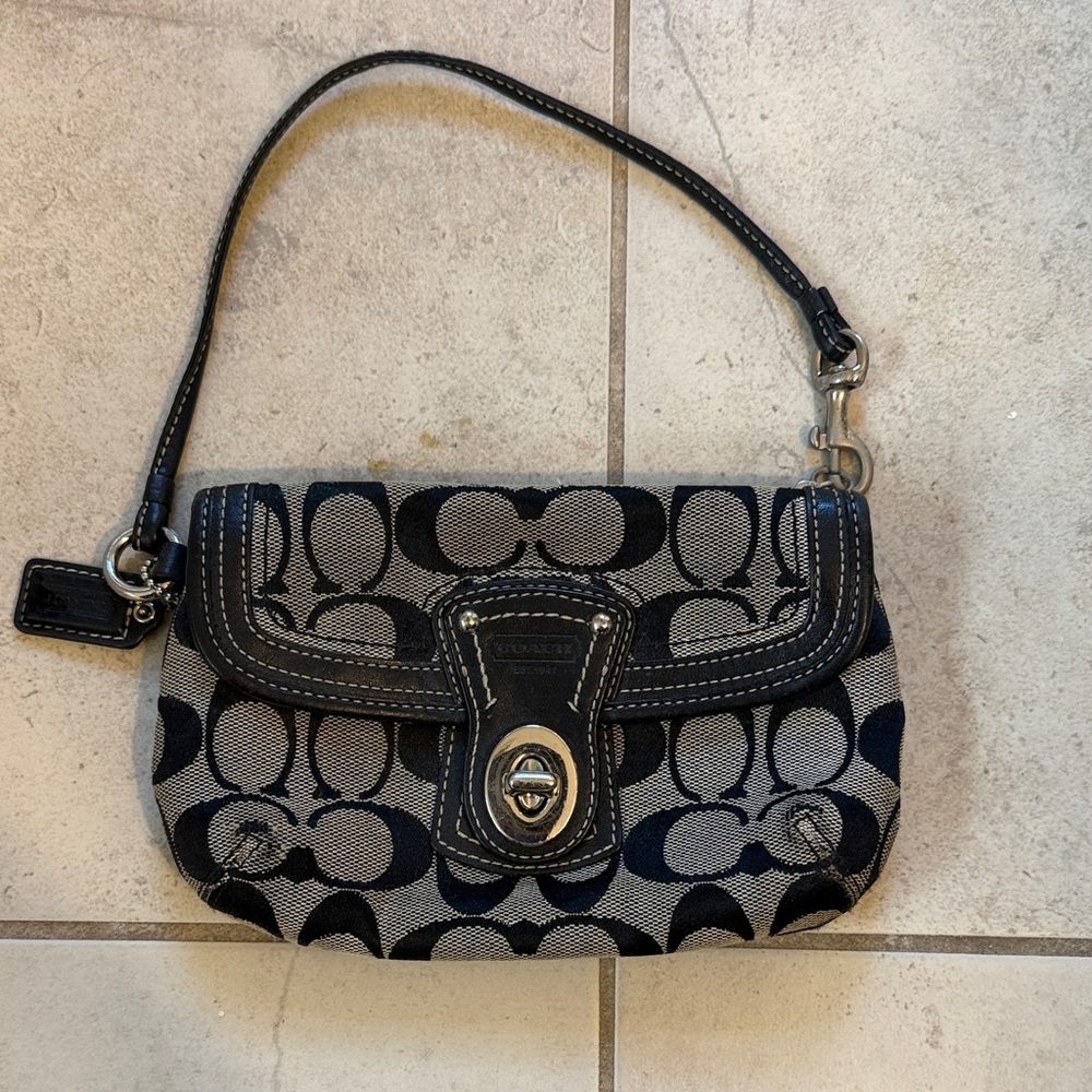 Coach Legacy Signature C Canvas Wristlet in black with leather trim.